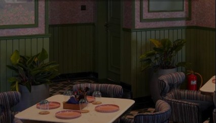 Green-panelled dining corner with striped armchairs