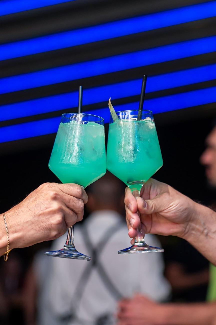 Friends toasting with blue cocktails