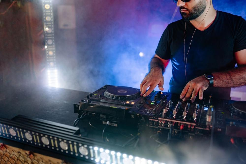 DJ mixing under stage lights
